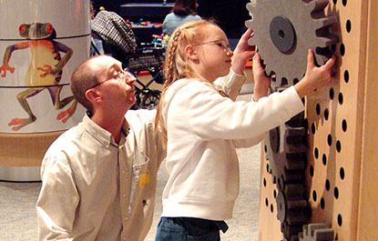 A child exploring gears in KidSpark.