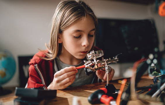 A child works on an electronics project.