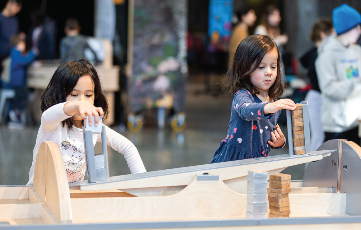 Two children interact with an exhibit in Our Climate Quest.