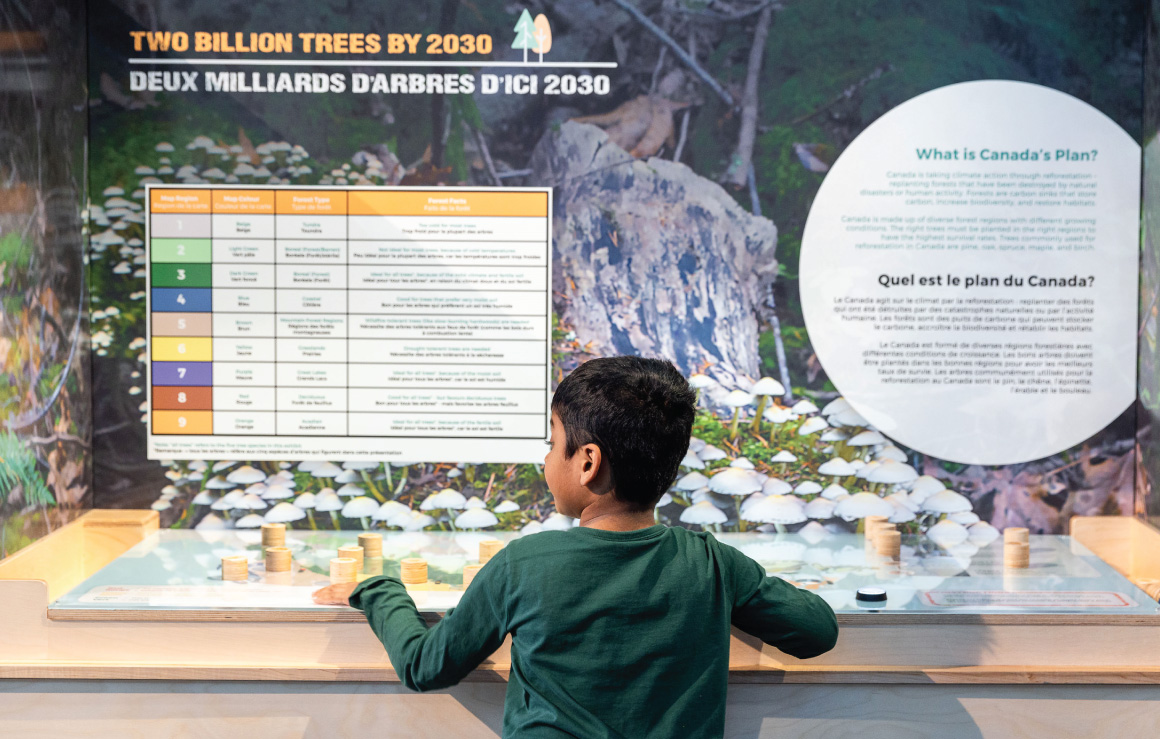 A child interacts with an exhibit in Our Climate Quest.