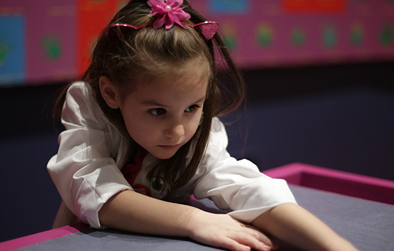 A young girl concentrates on learning at the Science Centre.