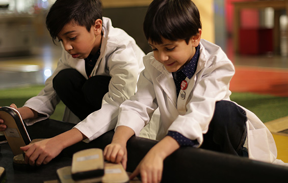 Two boys experiment with friction at the Science Centre.