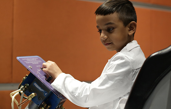 A boy experiments with the Rocket Chair at the Science Centre.