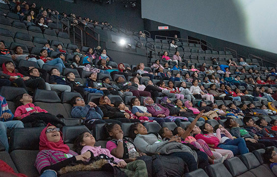 A group of people enjoying a film in the Ontario Science Centre's OMNIMAX Dome.