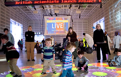 Adults watch as children play in the HotZone.