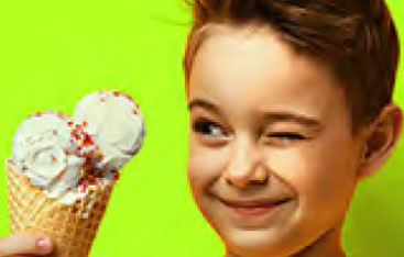 A boy looks at an ice cream cone.