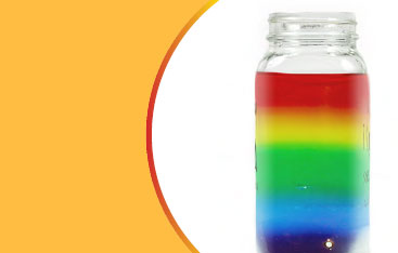 A jar filled with layers of rainbow coloured liquid.
