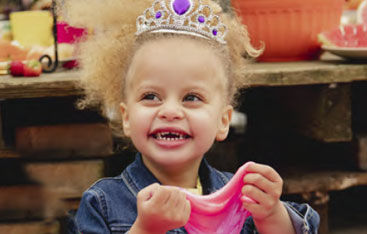 A young girl plays with homemade slime.