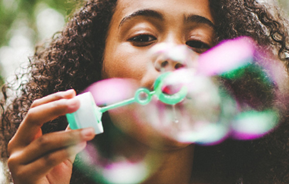 A girl blowing bubbles.