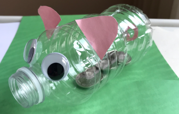 A plastic bottle repurposed as a piggy bank.