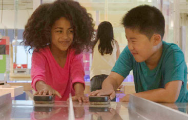 Two children experiment in the Weston Family Innovation Centre.