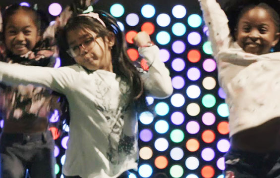 Three girls dance at a Sleepover at the Science Centre.