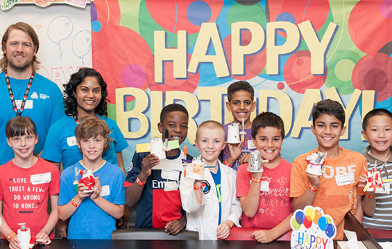 Happy children displaying their crafts at a Science Centre Birthday Party.