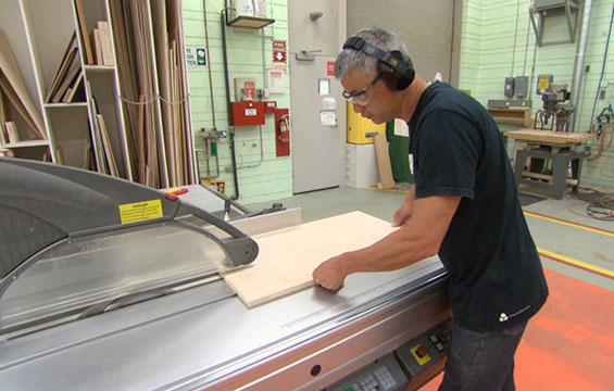 A staff member works on fabricating an exhibition.