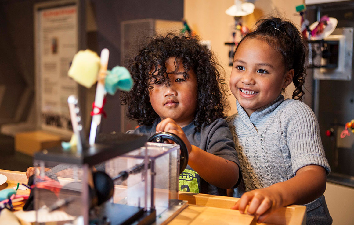 Two children experiment with a prototype exhibit.