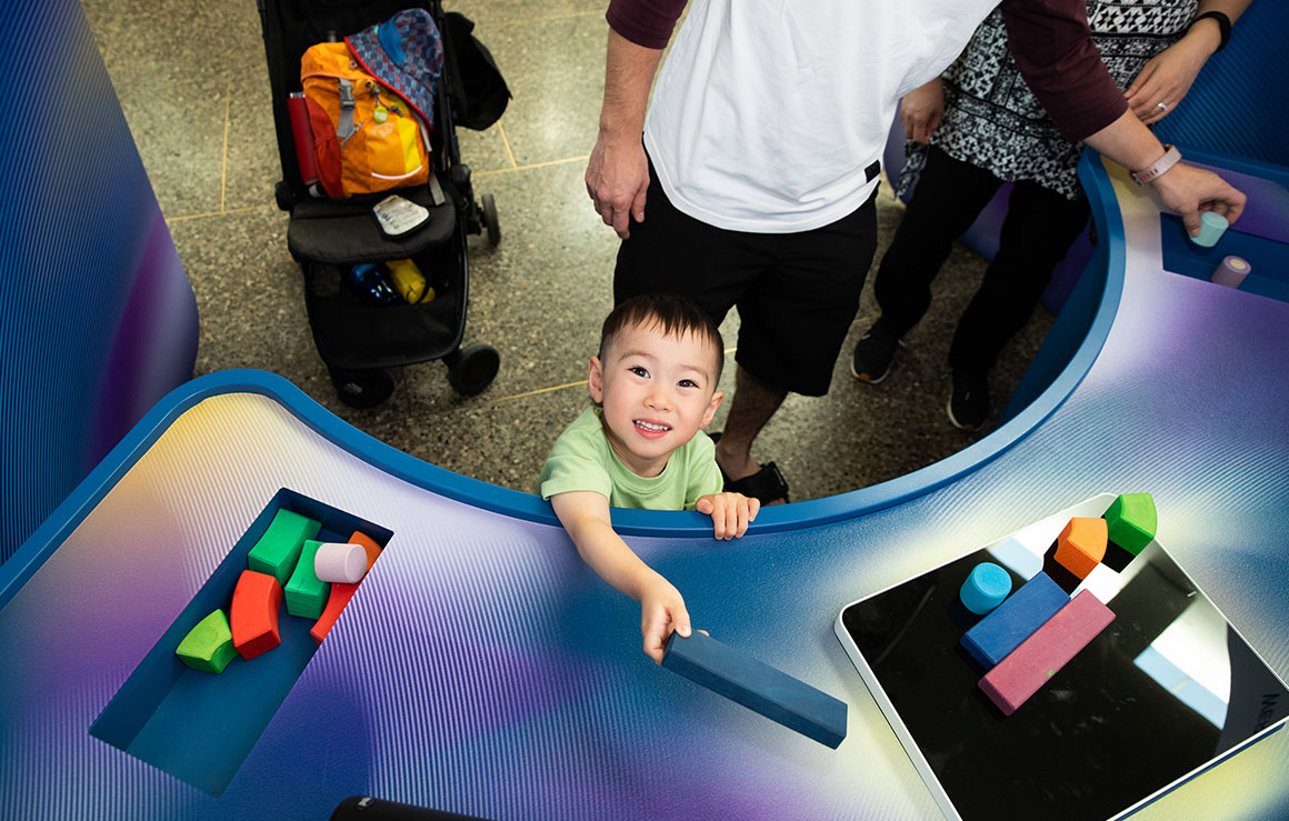 A child plays with blocks in the Flow State exhibit.