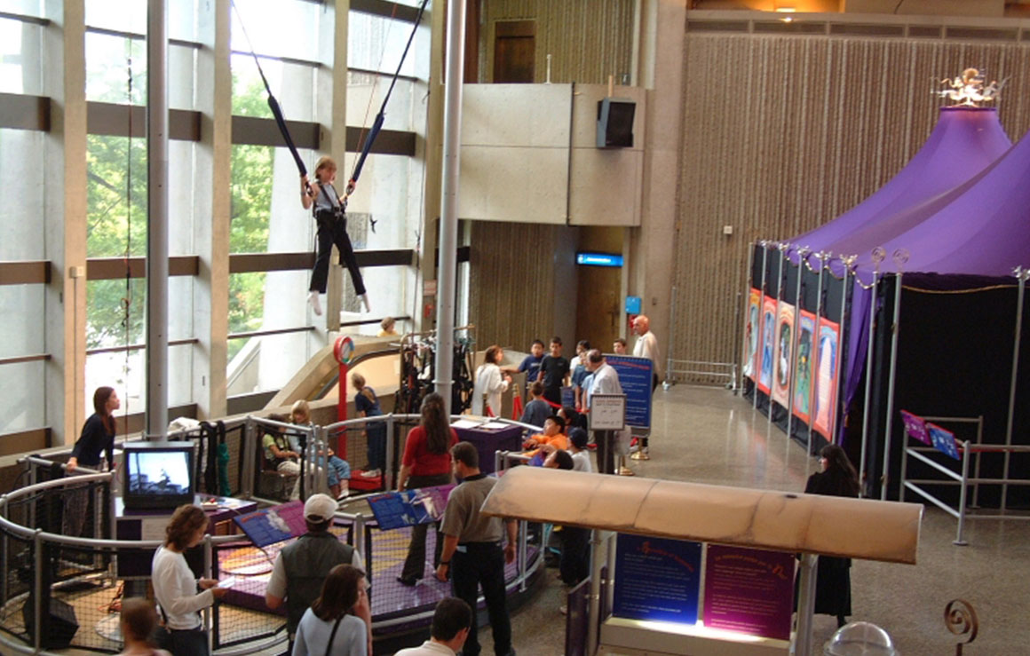 A person hangs suspended in the elastic acrobat exhibit.