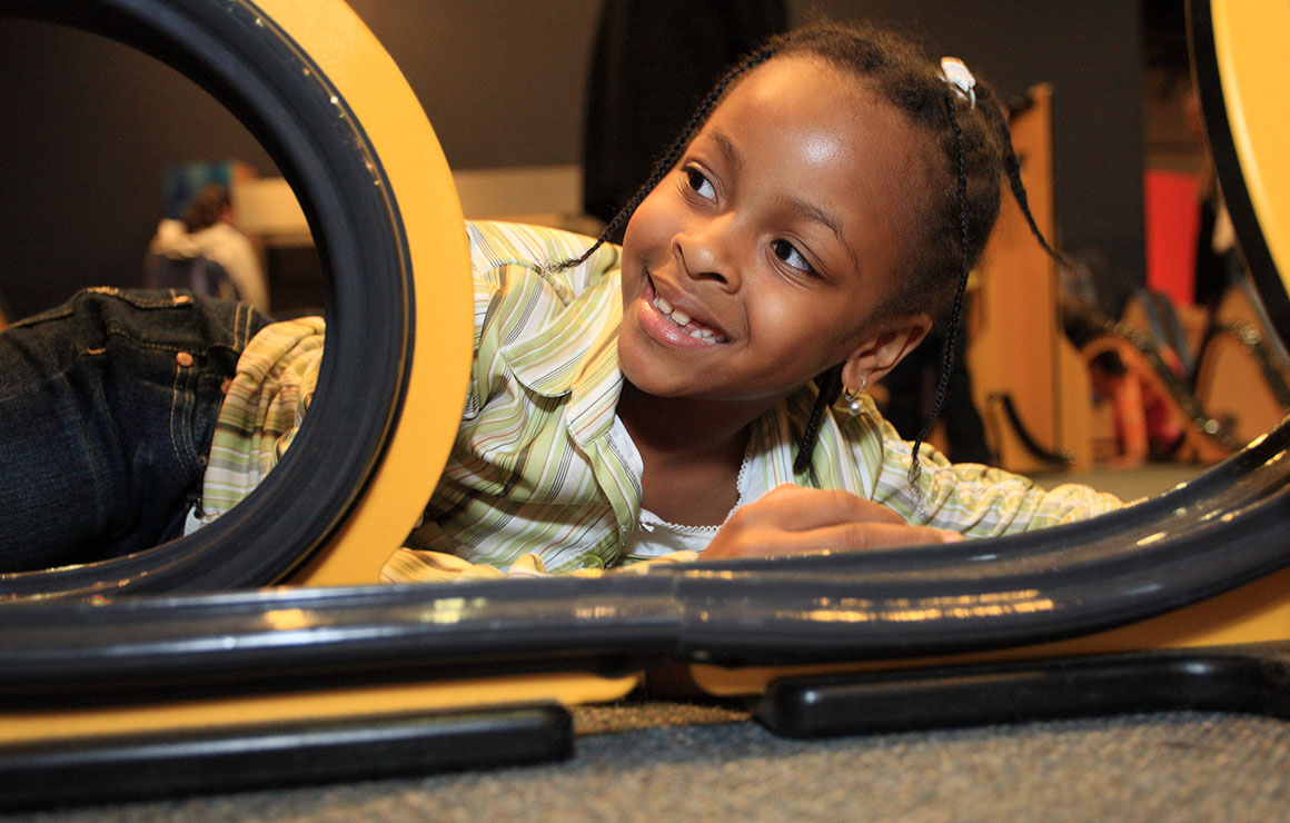 A young girl plays with the tracks in Motion Mania.