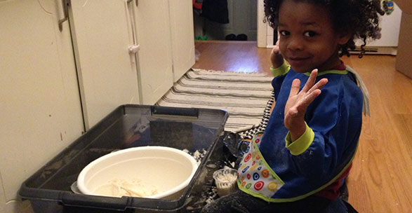 A child does a home science experiment.