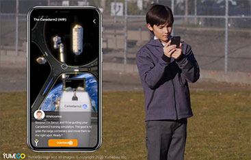 A child uses their phone outdoors while an image of a phone superimposed on top shows the AR experience.
