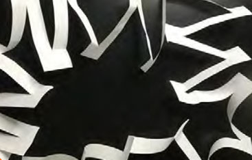 A piece of paper with many parallel slits cut in it.