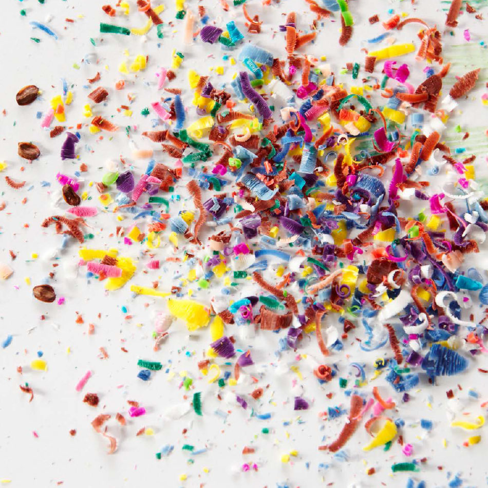 A small pile of different coloured crayon shavings.