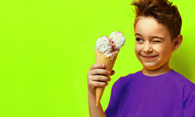 A boy looking at an ice cream cone.