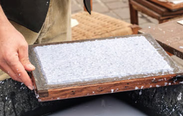 A close up of a person making paper.