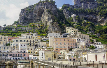 The city of Amalfi with mountains in the background.
