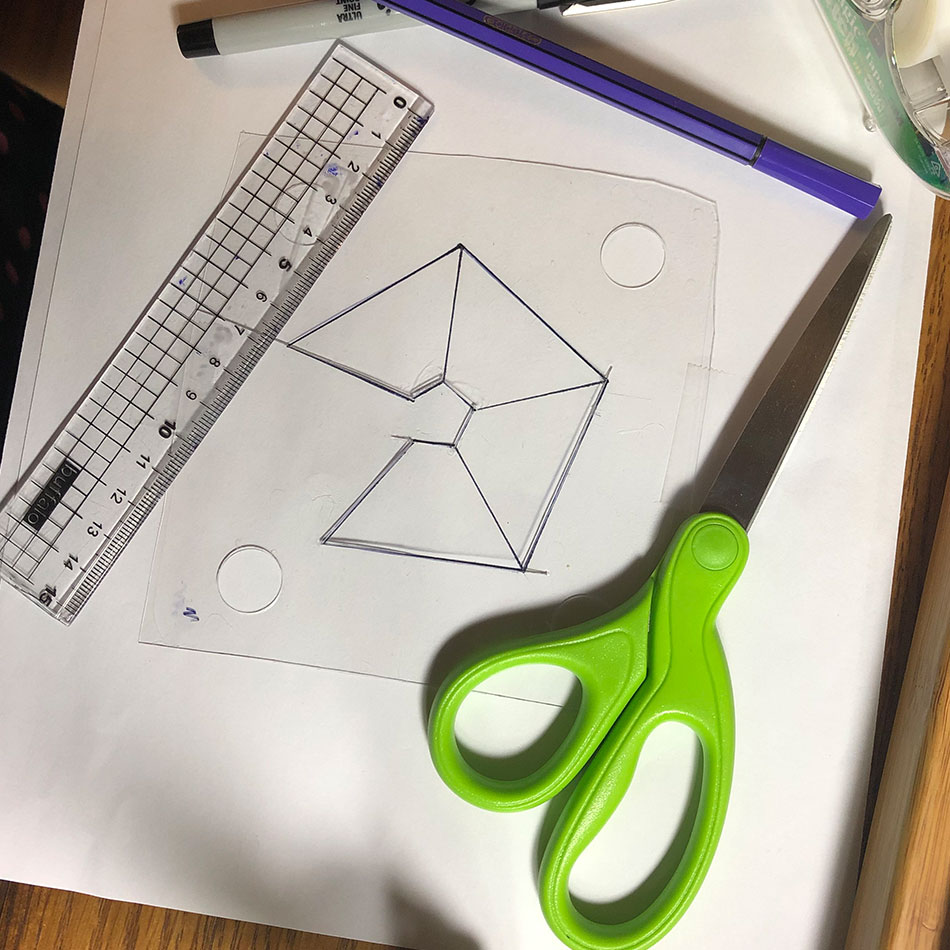 Various tools for this project including scissors, a ruler and a sheet of plastic.