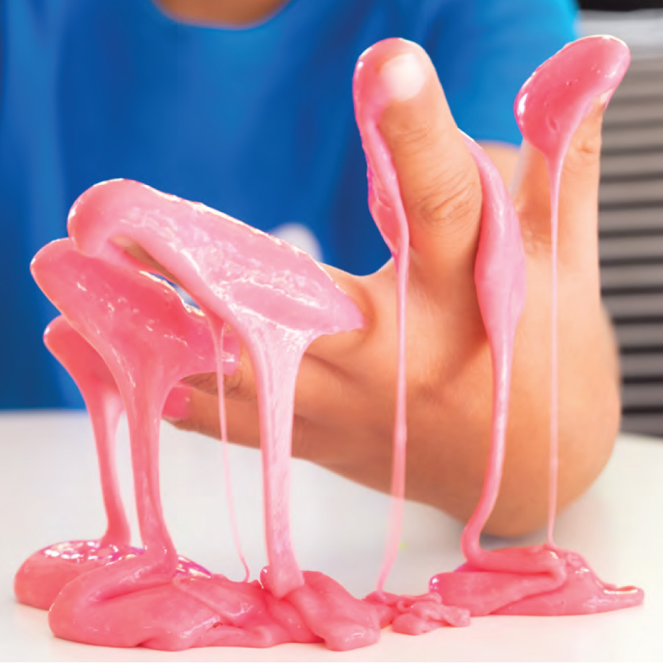 A close-up of a child's hand dripping with pink slime.