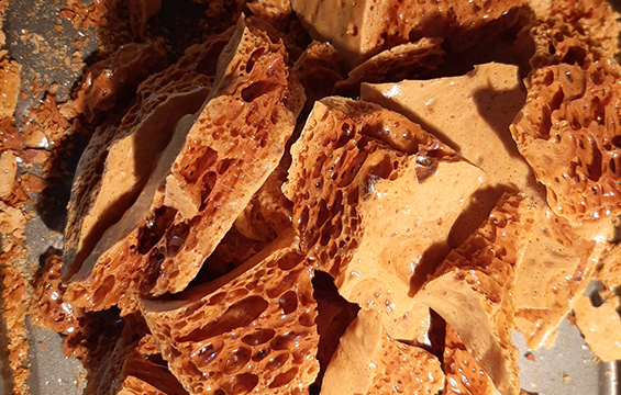 A close-up of finished toffee candy, showing the bubbles inside the candy.