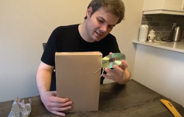 An Educator inserts a CD into a cardboard box to make a CD Spectrometer