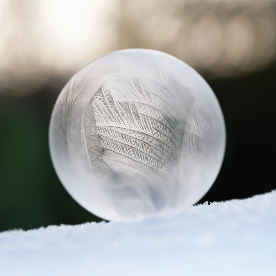 A frozen ice orb sits in the snow.