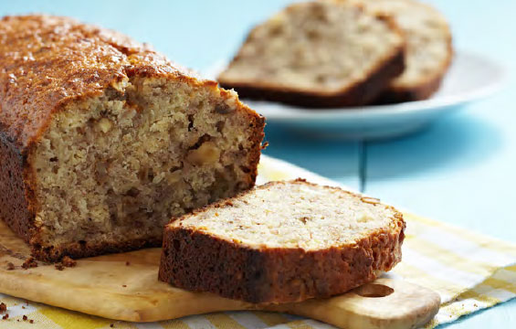 Slices of banana bread next to a loaf.
