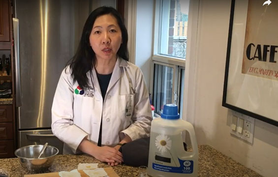 A Science Centre host at a counter with laundry detergent on it.