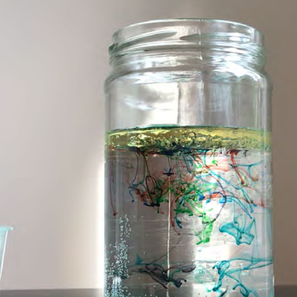 Swirls of coloured liquid in a jar.
