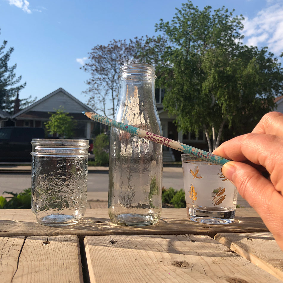 Glass containers and a pencil.