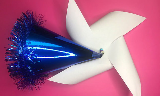 A party hat with a pinwheel on it.
