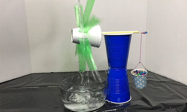 A machine made of household objects for demonstrating hydro power.