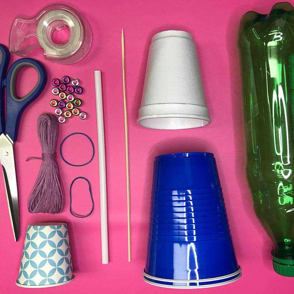 Home materials including plastic cups, a plastic bottle, scissors and more.