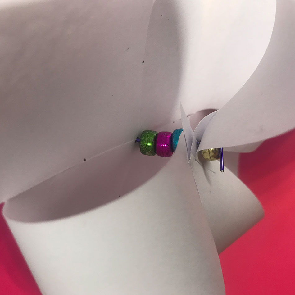 Beads inside a folded up pinwheel.