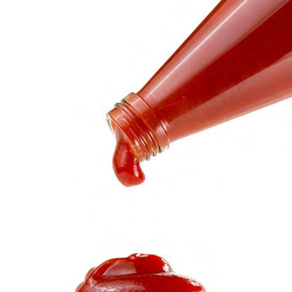 Ketchup dripping from a bottle.