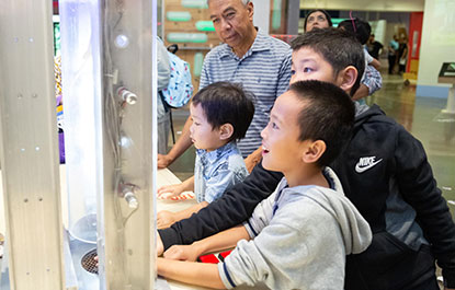 A family playing in the Weston Family Innovation Centre.