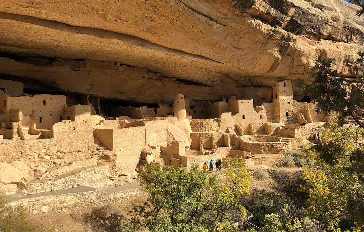 Buildings carved into a rock wall.