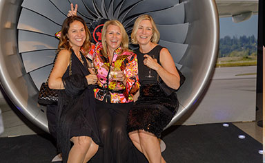 People sitting in a replica of an airplane engine.