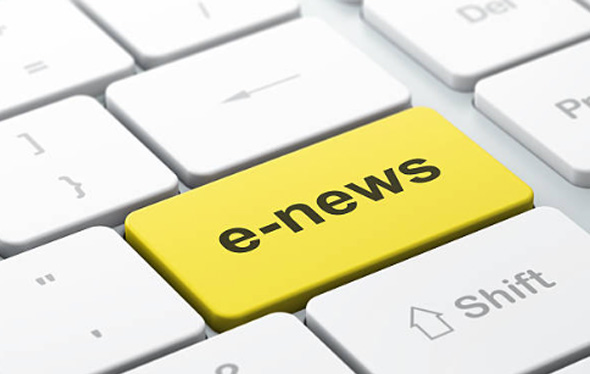 Close up of a keyboard with a yellow key that says e-news