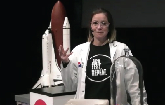 An educator presents a model rocket
