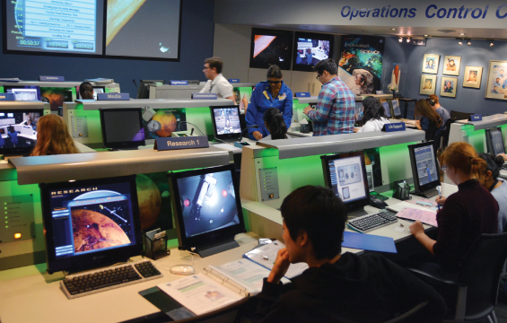 Several students work at their workstations in Mission Control in the Challenger Learning Centre