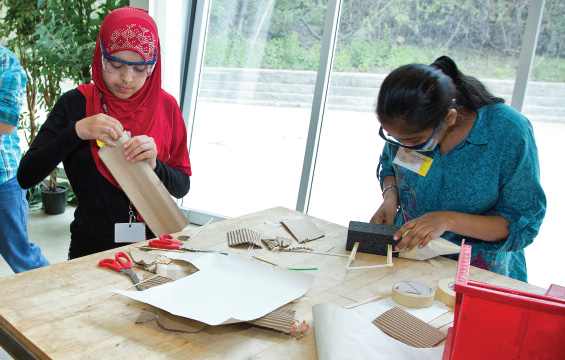 Two students construct a glider in a workshop